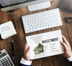What is real estate and why is it considered an investment?